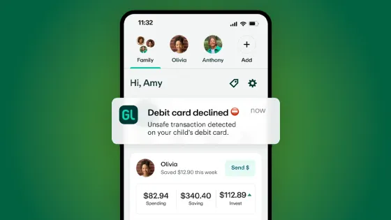 Phone displaying the Greenlight app Family dashboard with a highlighted notification saying, "Debit card declined. Unsafe transaction detected on your child's debit card"