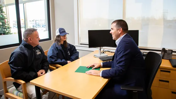 A North Easton Savings Bank lender talking to two customers in an office