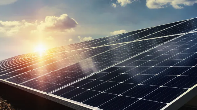 Solar panels with a sunset in the background