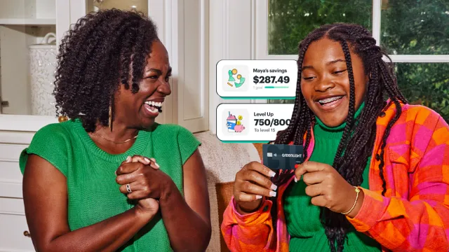 Mother and daughter sitting together and smiling, while the daughter holds a Greenlight debit card. In the background there are two graphic boxes saying, "Maya's savings $287.49" and "Level Up 750/800 to level 15"