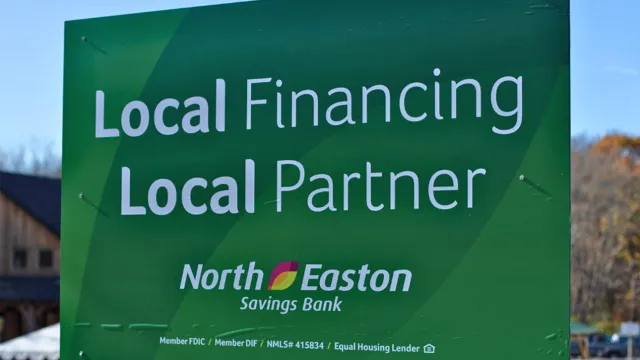 A sign that says, "Local Financing Local Partner" with the North Easton Savings Bank logo below and Member FDIC / Member DIF / NMLS# 415834 / Equal Housing Lender